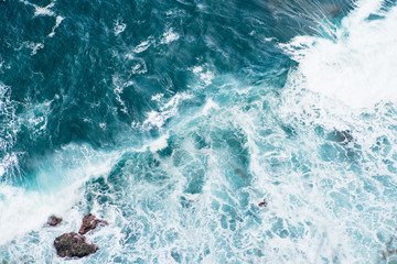 Fototapeta na wymiar Wild blue Waves at a cliff