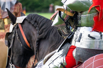 Close up of a medieval knight wering armour sitting on horseback
