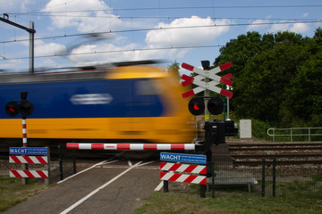 Train passing a level crossing with high speed