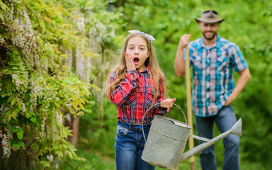 little girl and happy man dad. earth day. family farm. spring village country. father and daughter on ranch. ecology. Watering can and shovel. Beautiful female florist. Passionated about her job