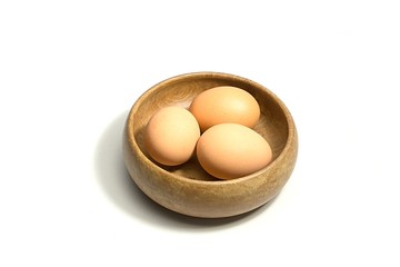 eggs in wooden bowl isolated on white background