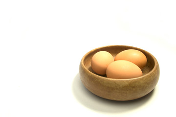 eggs in wooden bowl isolated on white background