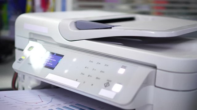 Documents printing concept : Business man hand pressing button machine supplies in control panel laser printer for copy scanner and printing document report graph chart in busy office 