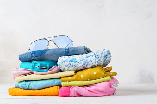 Stack of folded colorful clothes. Modern casual clothing.