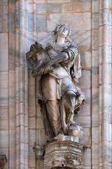 Fototapeta premium Statue of Saint on the facade of the Milan Cathedral, Duomo di Santa Maria Nascente, Milan, Lombardy, Italy