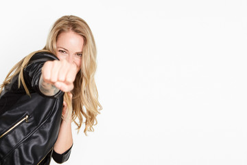 Young beautiful lady smiling in a boxing position on white background with copy space