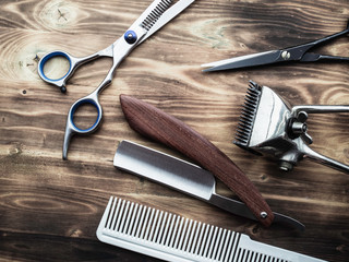 old rusty barber shop tools on wood background