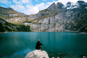 Hiker enjoing beautiful view of Lago di Braies or Pragser wildsee, Italy.