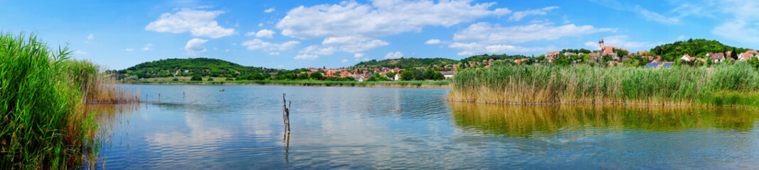 Fototapeta na wymiar Panoramic photo of Tihany village on the hills with the inner lake and reed in the foreground at lake Balaton in Hungary