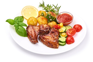BBQ chicken wings with sesame seeds, spicy grilled meat with baked potatoes, close-up, isolated on white background