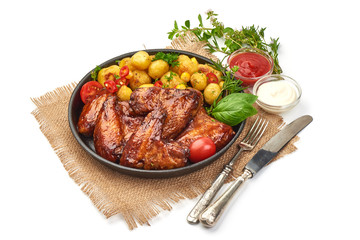 Grilled chicken wings with baked potatoes, Restaurant food, close-up, isolated on white background