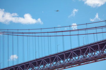 plane flies over the hanging bridge