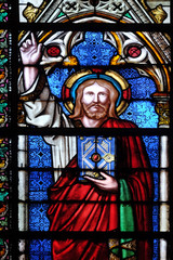 Fototapeta na wymiar Christ blessing, stained glass window in the Basilica of Saint Clotilde in Paris, France 