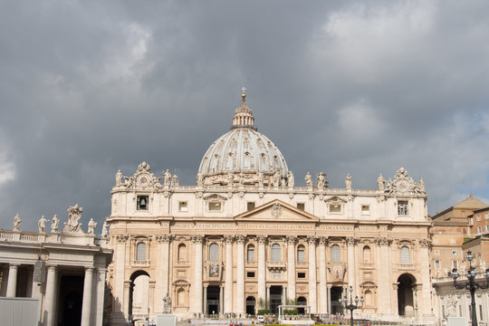 Facade of The Apostolic Palace with clouds on background, Vatican city state, Italy.