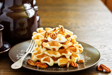 Homemade waffles with caramel and pecans.