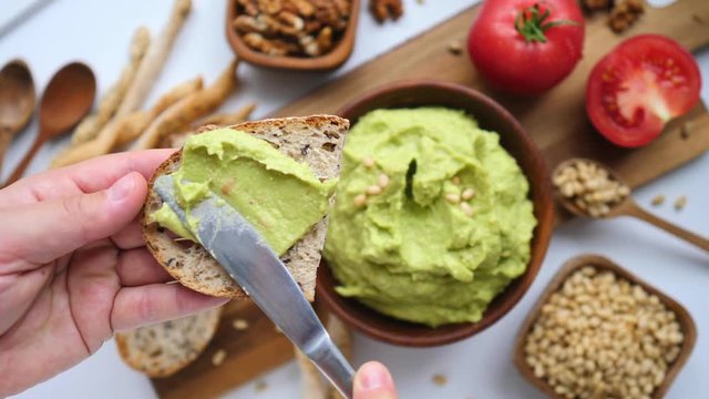 Hand Cooking Healthy Food By Spreading Avocado Smash On Toast