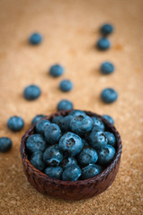 Freshly picked blueberries in woven natural screwpine leaf bowl. Juicy and fresh blueberries with on rustic table. Bilberry on wooden Background. Blueberry antioxidant. Concept for healthy eating.