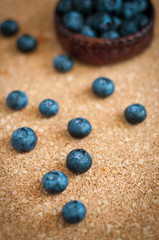 Freshly picked blueberries in woven natural screwpine leaf bowl. Juicy and fresh blueberries with on rustic table. Bilberry on wooden Background. Blueberry antioxidant. Concept for healthy eating.