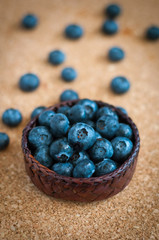 Freshly picked blueberries in woven natural screwpine leaf bowl. Juicy and fresh blueberries with on rustic table. Bilberry on wooden Background. Blueberry antioxidant. Concept for healthy eating.