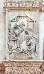 Fototapeta na wymiar Nativity, Birth of Jesus, panel on the left door of San Petronio Basilica in Bologna, Italy