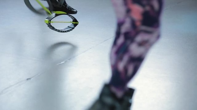Legs of fitness women jumping on kangoo jump
