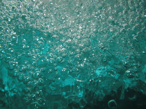 Small air bubbles in the water. Underwater background. Aquamarine bubbles. Water splash. Turquoise bubbles. Aquamarine water. Turquoise water.