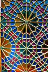 Traditional oriental window pattern made of little colorful glasses. Detail of the stained glass window. A geometric pattern on the side of the Palace of Shaki Khans. Sheki, Azerbaijan.