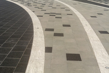 The area is covered with tiles made of white, gray and black stones.