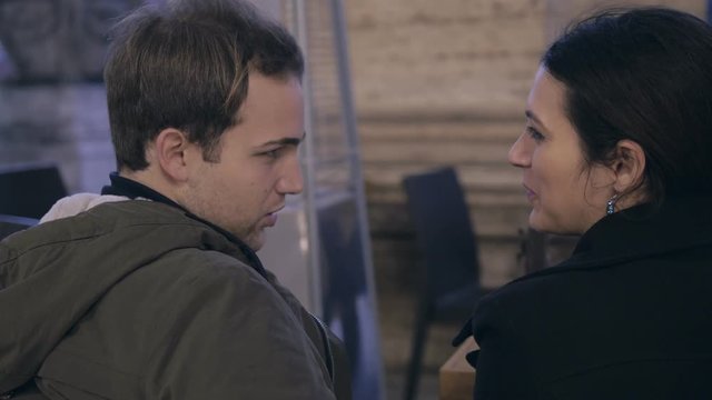 Betrayal scene.Young man kissing girlfriend and touching hide other woman