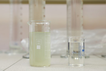 chemical laboratory concept. contaminated and purified water in vessels