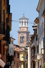Fototapeta na wymiar Torre dei Lamberti - medieval tower of the Lamberti XI century - 84 m. Piazza delle Erbe, UNESCO world heritage site in Verona, Italy