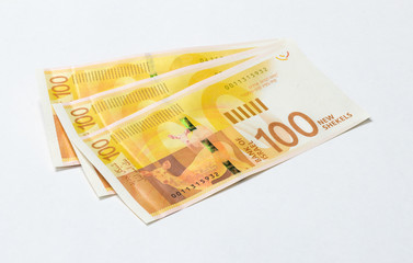 Three  banknotes of a new type with a portrait of poet Lea Goldberg worth 100 Israeli shekels isolated on a white background