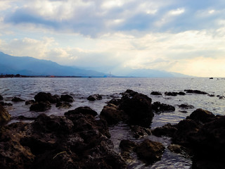 Natural Rocky Beach Seaside In The Cloudy Twilight Of The Sky At Umeanyar Village, North Bali, Indonesia