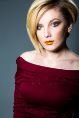 Blonde woman with makeup and nails art closeup
