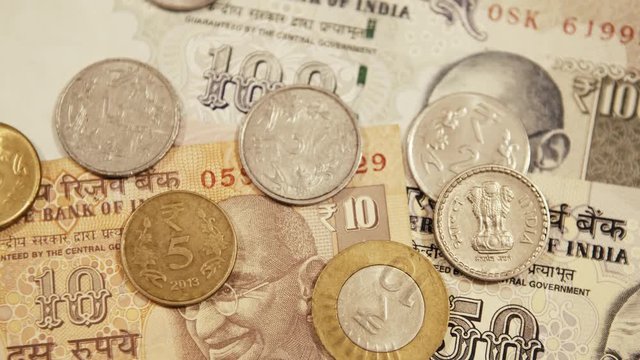 Smooth Movement of the Camera, Video Starts Of Blurry, and then focuses on the Cash that is laying on the Table.