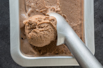 Homemade banana and chocolate ice cream in metallic container. Close up. Top view. Mocha Mousse color