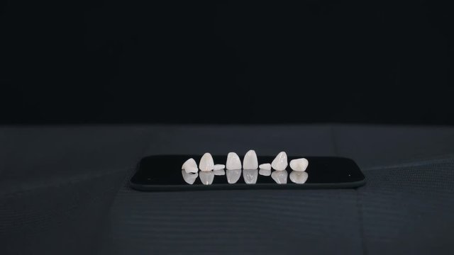 dental veneers on black background