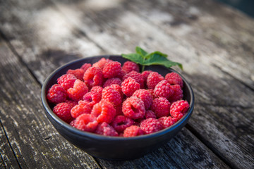 Beautiful, freshly picked garden raspberries in the summer. Summer berries, natural food, healthy dessert.