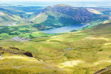 Track to Snowdon summit taking ranger path, North Wales, United Kingdom, view of the mountains, lake from the above, selective focus