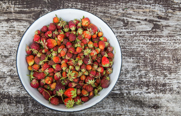 Beautiful, freshly picked garden strawberries in a bowl. Healthy vegan, ecological food in summer.