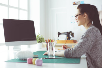 Portrait of Fashion designer working in her studio