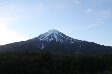 The top of the volcano in Kamchatka is shrouded in vapors, a beautiful mountain landscape.