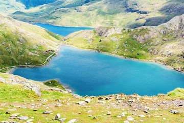 Fototapeta na wymiar View of beautiful blue lakes in Snowdonia National Park, North Wales, mountains on the back, selective focus