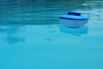 Fototapeta na wymiar Floating Swimming Pool Dispenser in Water