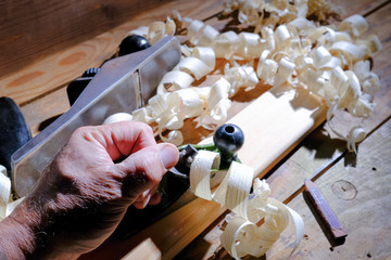 Carpentry tools for wood processing, shavings on a wooden table.