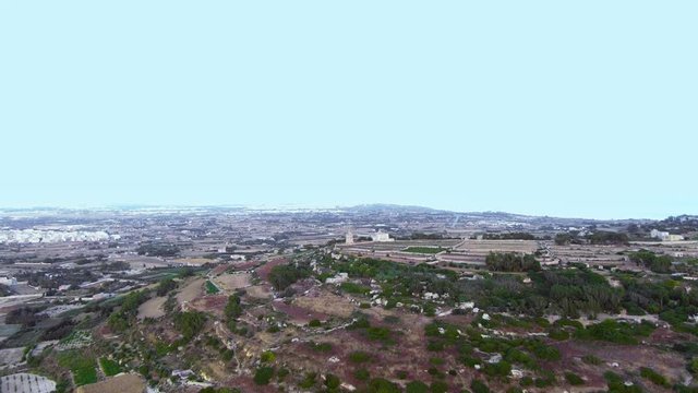 Aerial video of a forward-facing flight towards Verdala Castle and the Buskette Fields that overlook Siġġiewi also know as Citt&agrave; Ferdinand and named after Hughes Loubenx de Verdalle