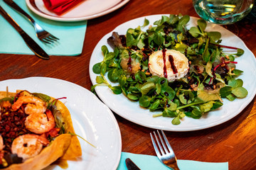 Fresh salad with smoked chicken. Fresh vegetables, herbs, olives, sauce and salad dressing at the counter.  Details close-up and soft focus. Vegetarian food and snacks. 