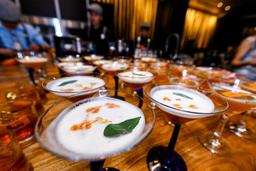 Set on alcoholic cocktails at the bar. Catering Party Event. Closeup Photo of Tower Glassware with Luxury Alcoholic Drink in Buffet for Guests. On a bar background. classic cocktail set in a bar