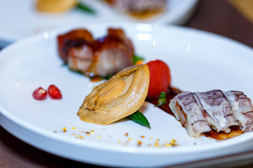  Beautifully presented dish of sea food. Tasty exotic sauce. Appetizing and healthy food. Photo for culinary magazines, websites and backgrounds.