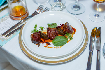 Beautifully presented dish of meat and vegetables. Tasty grilled meat sauce. Appetizing and healthy food. Photo for culinary magazines, websites and backgrounds.